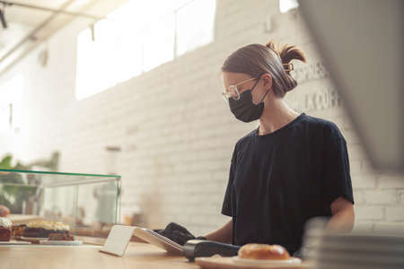 Woman writing in electronic tablet order of clientsの写真素材