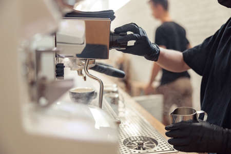 Female person is preparing cappuccino in coffeehouseの写真素材