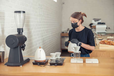 Woman in glasses having hard-working day in cafeteriaの写真素材