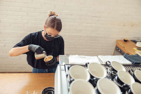 Female person preparing cup of coffee to serveの写真素材