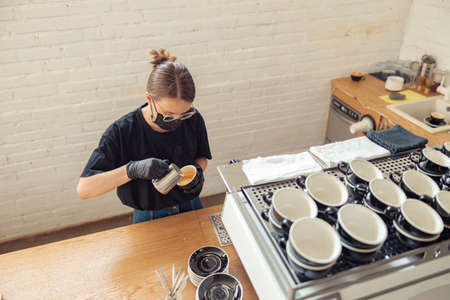 Woman holding cup and using special toolsの写真素材
