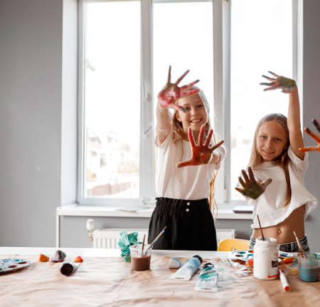 Multi-colored palms of kids after drawing lessonsの写真素材
