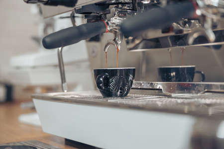 Professional coffee machine brewing espresso in cafeteriaの写真素材