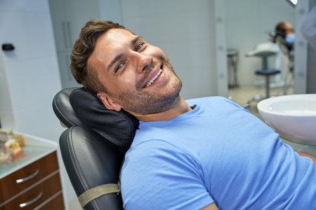 Joyous patient of dental clinic resting in dental chairの写真素材