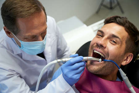 Smiley patient feeling good during his dental treatmentの写真素材