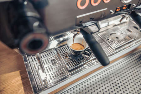 Professional coffee machine brewing espresso in coffee shopの写真素材