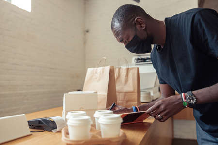 Black man working deliveryman in covid-19 pandemicの写真素材