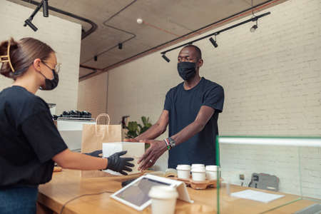 Employees in mask working together in pandemicの写真素材