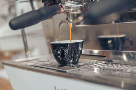 Professional espresso machine brewing coffee in coffee shopの写真素材