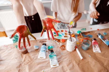 Kids are showing palms painted with watercolorの写真素材