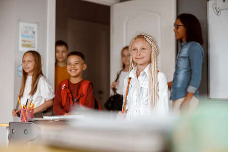 Happy children standing in class at schoolの写真素材