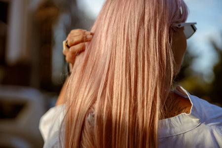 Young woman touching her hair on the streetの写真素材