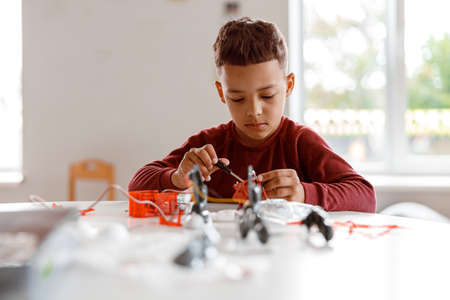 Kid constructing model with constructor details in schoolの写真素材