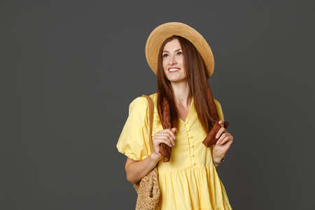 Beautiful woman in straw hat standing in studioの写真素材
