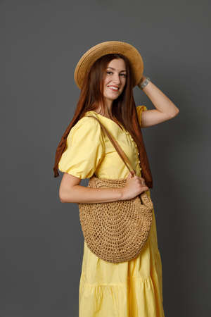 Beautiful joyful woman in summer dress standing in studioの写真素材