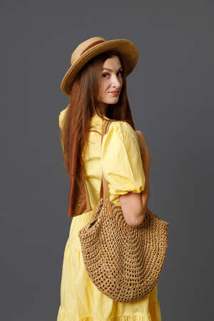 Attractive woman in straw hat standing in studioの写真素材