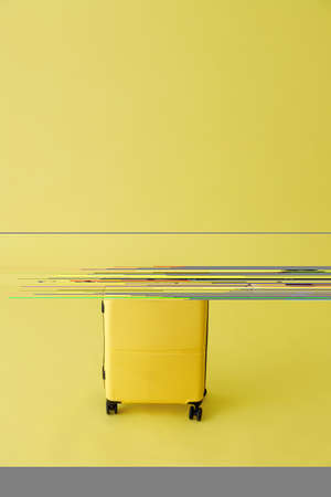 Yellow travel suitcase or trolley luggage bag in studioの写真素材