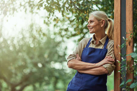 Smiling middle aged caucasian business woman in gardenの写真素材