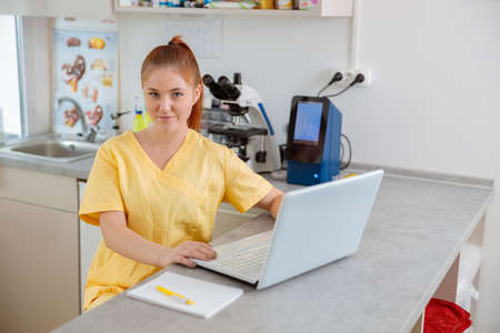 Woman vet sitting in interior of modern clinicの写真素材