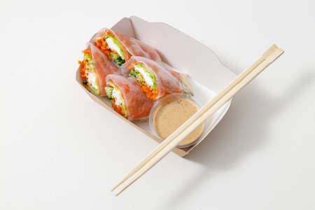 Vegan and tasty in paper package with chopsticksの写真素材