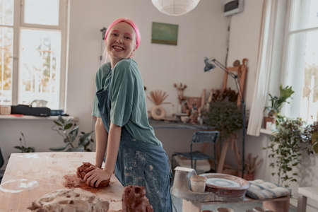 Handmade artist shaping clay while making ceramics in workshopの写真素材