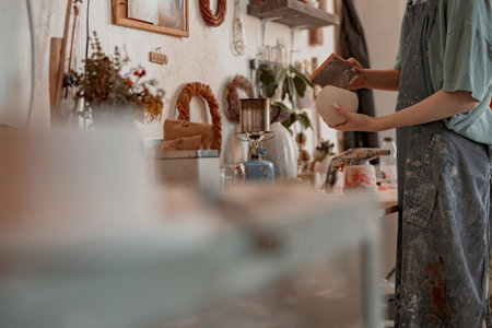 Business woman works at her pottery storeの写真素材