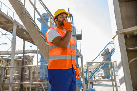 Experienced engineer working hard at construction plantの写真素材