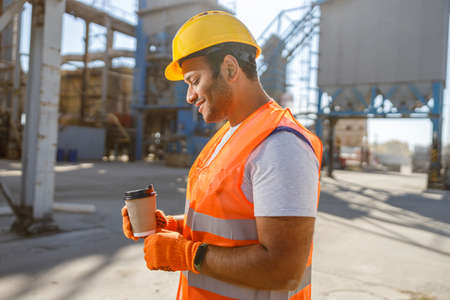 Skillful multiethnic foreman working at construction plant