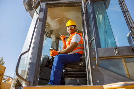 Manual worker driving cargo truck in plantの写真素材
