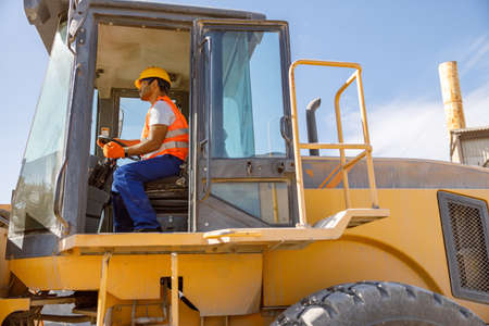 Manual worker driving cargo truck in plantの写真素材