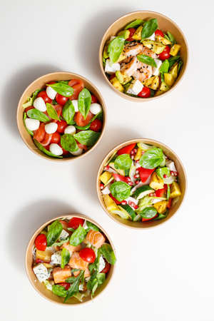 Selection of different salads in bowl at the tableの写真素材