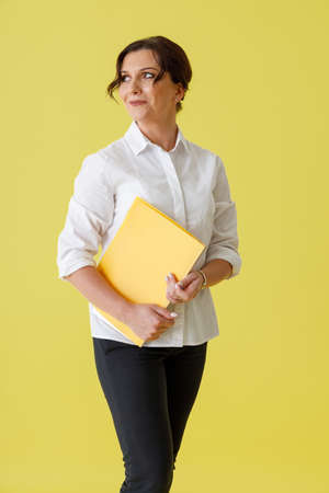 Beautiful woman office worker holding document folderの写真素材