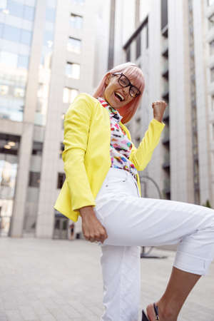 Joyful female making yes gesture with her armの写真素材
