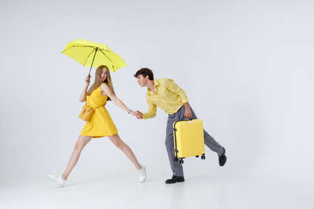 Happy couple travelers walking hand in hand in studioの写真素材