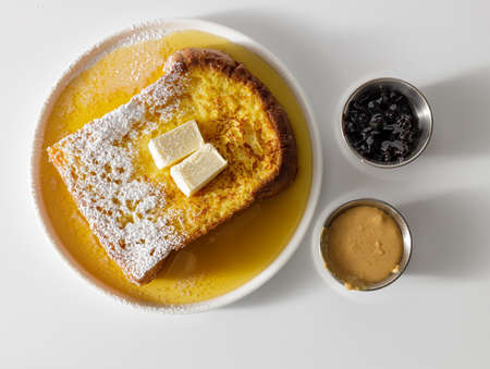Butter melting on fresh piece of bread