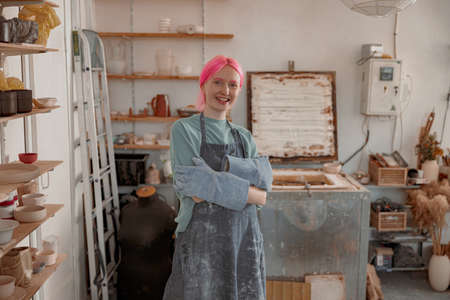 Female potter master working on craft in clay studioの写真素材