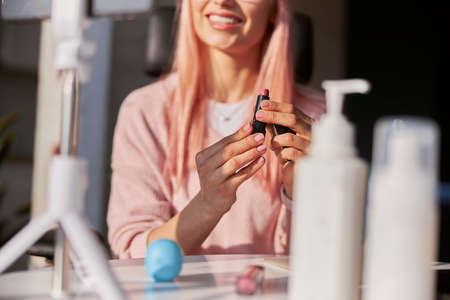 Professional makeup artist opens lipstick shooting new tutorial at table