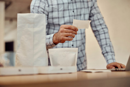 Male hand holding label paper for orderの写真素材
