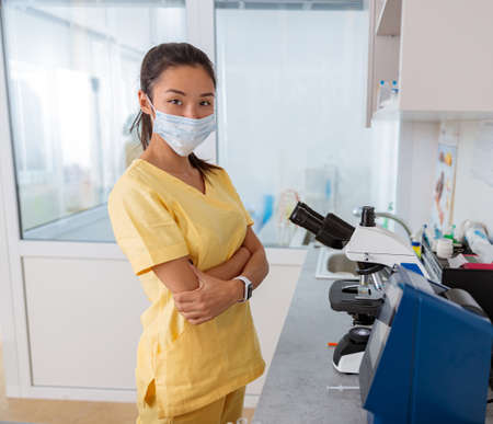 Young vet assistant stands at workplace in laboratoryの写真素材
