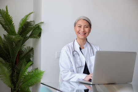 Asian woman medical worker smiling at cameraの写真素材