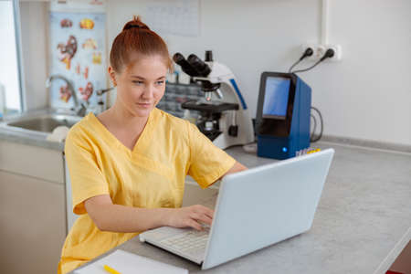 Female vet assistant working in clinical laboratoryの写真素材