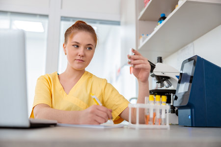 Woman vet sitting at desk in animal clinicの写真素材