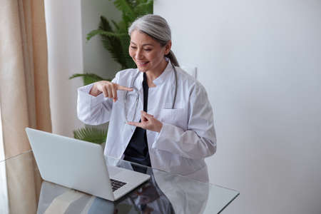 Woman doctor communicating with patient using sign languageの写真素材
