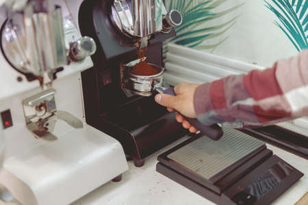 Process of pouring ground coffee into the filterの写真素材