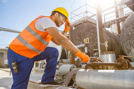 Experienced engineer working hard at industrial plant