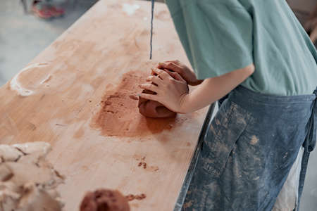 Photo of process of creating pottery by hands in workroomの写真素材