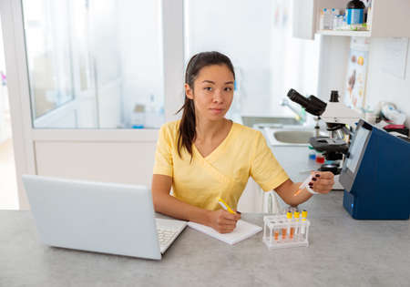 Young laboratory assistant works in animal clinicの写真素材