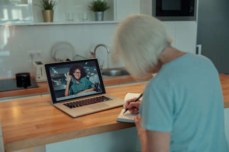 Senior woman working with laptop at homeの写真素材