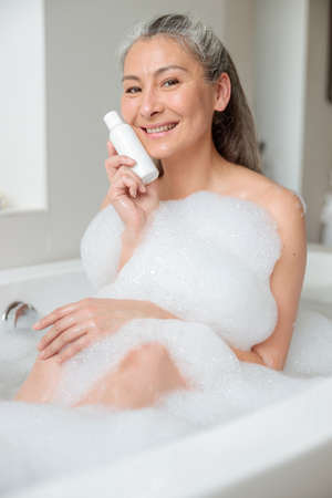 Female holding natural skincare or body care cosmeticの写真素材