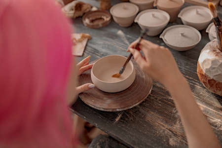 Potter master working on craft in clay studioの写真素材
